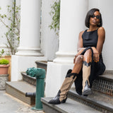 Woman sitting on steps in an urban setting with classical architecture