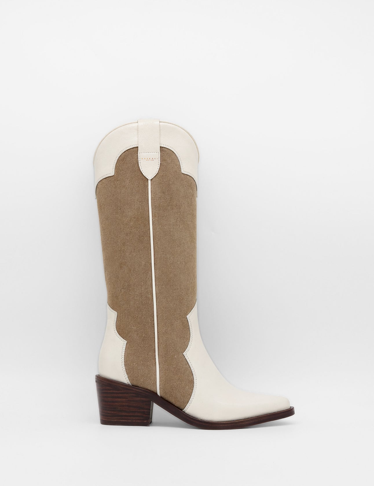 Brown and white cowboy boot on a light gray background