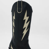 shaft detail on black leather kiss boots with ivory lighting bolt and side pull on tab