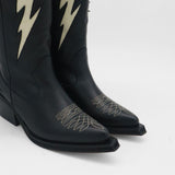 close up of semi pointed toe details on black leather kiss cowboy boots with western inspired stitching