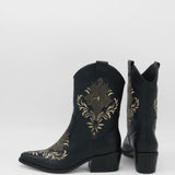 angled back view of black leather knox cowboy boots with side pull on tab and low stacked heel