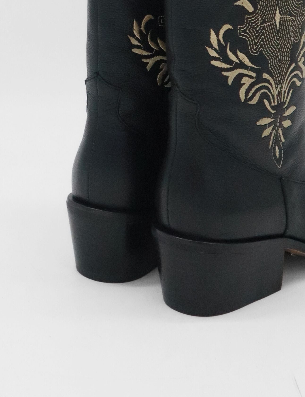 close up of black leather knox boots with stacked heel and embroidery stitching 