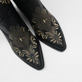close up of pointed toe details on black leather knox cowboy boot with embroidery details 
