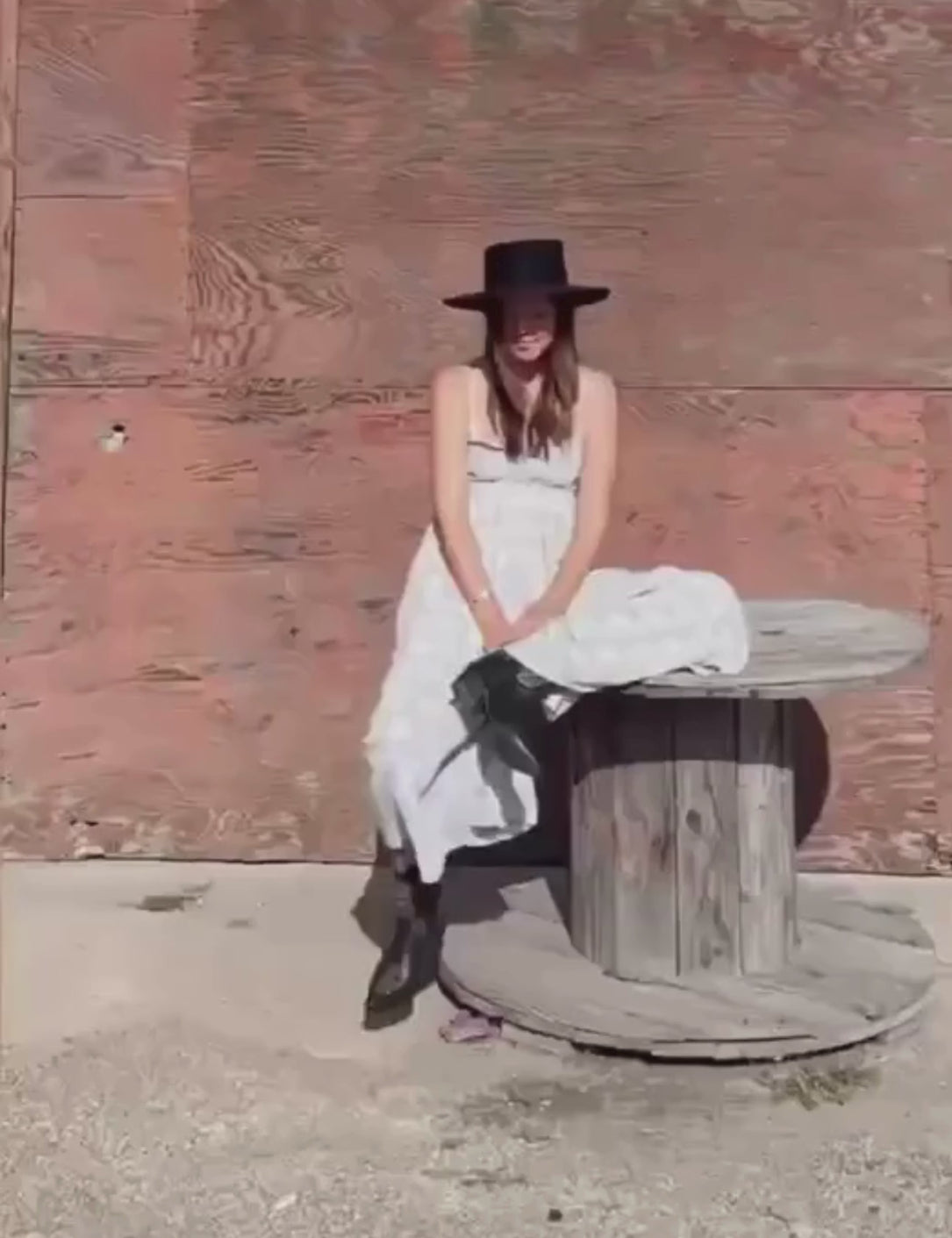 video of women wearing black unstoppable cowboy boots with white maxi dress outdoors 